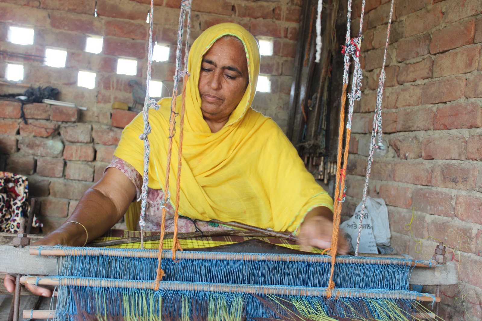 Woman weaving at the loom
