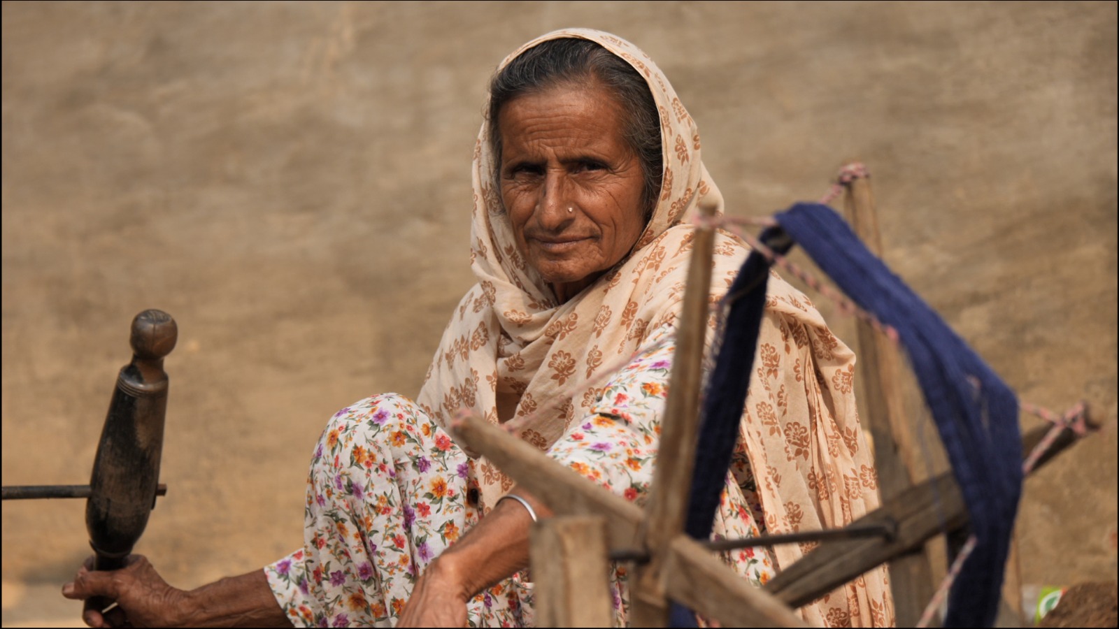 A woman at the charkha